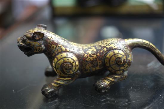 A Chinese parcel gilt bronze figure of a tiger, in Song dynasty style, length 18cm, together with a fitted hardwood box